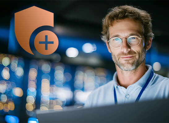 A professional with a laptop in front of a security icon, with a focus on industrial cybersecurity and secure automation systems