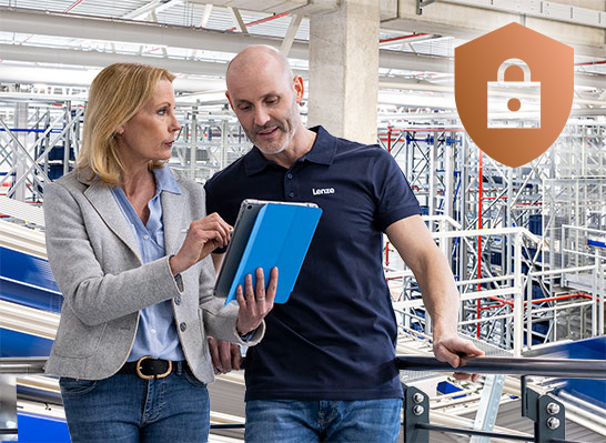 A man and a woman stand in front of a goods distribution centre with a tablet and look into the system. Illustration of cyber security.