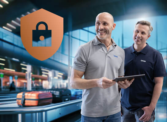 Two men stand in a modern warehouse, one holding a tablet, a large padlock symbol in the background.