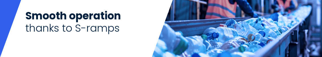 Several plastic bottles on a conveyor belt with a person in a high-visibility vest and helmet in the background